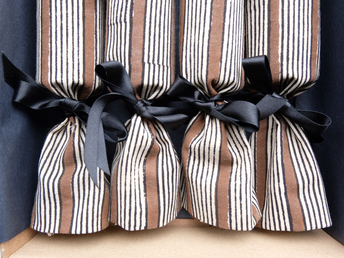 close up of four luxury Christmas crackers in a box 