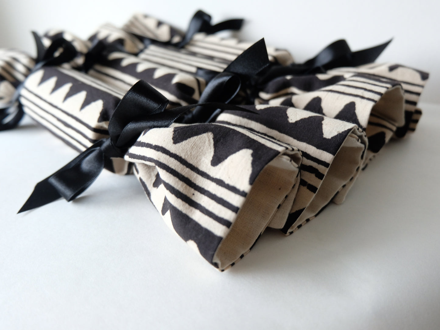 close up of ends of four peak print luxury Christmas crackers 