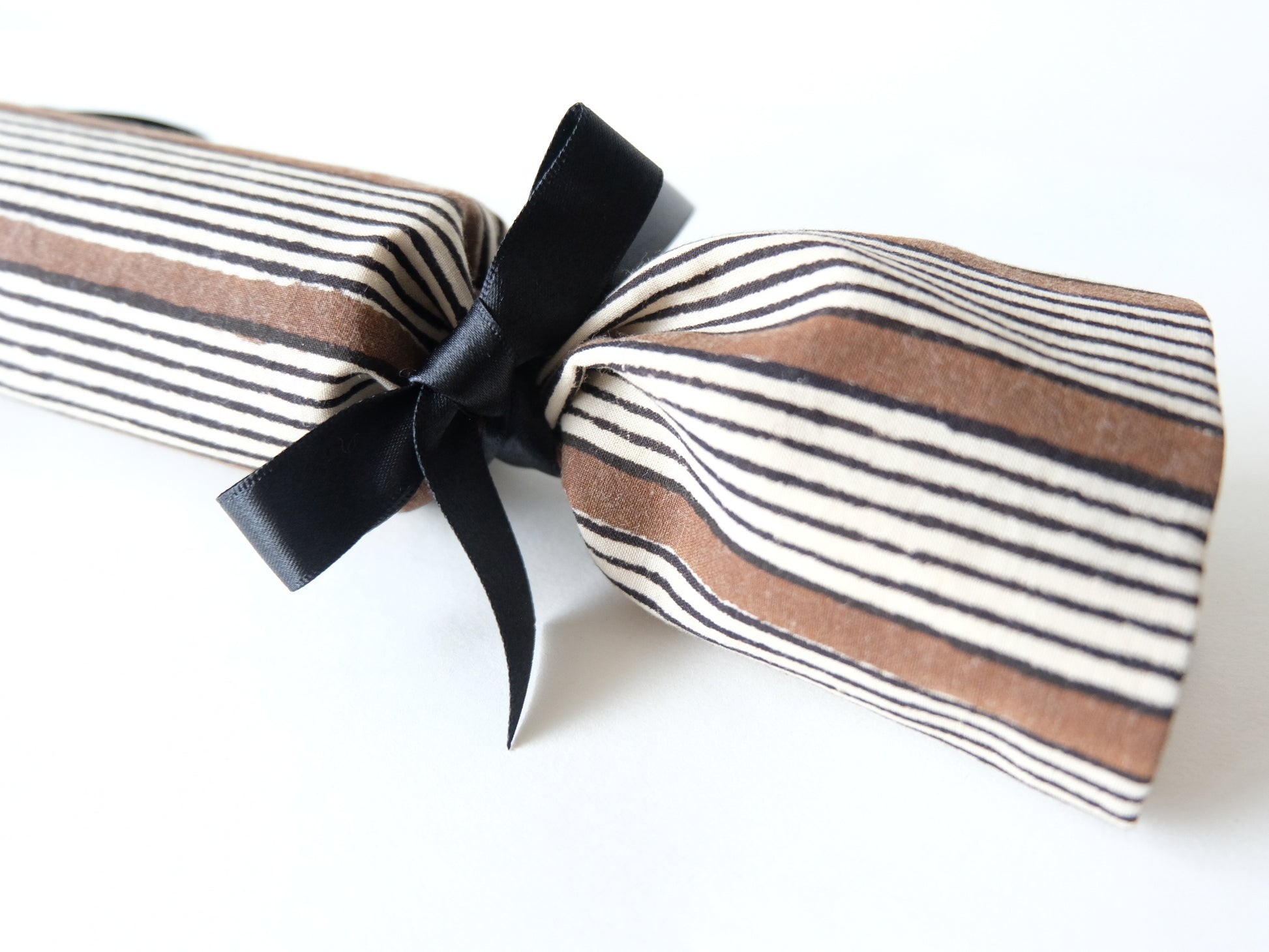 a close up of a single stripe print reusable luxury Christmas cracker 