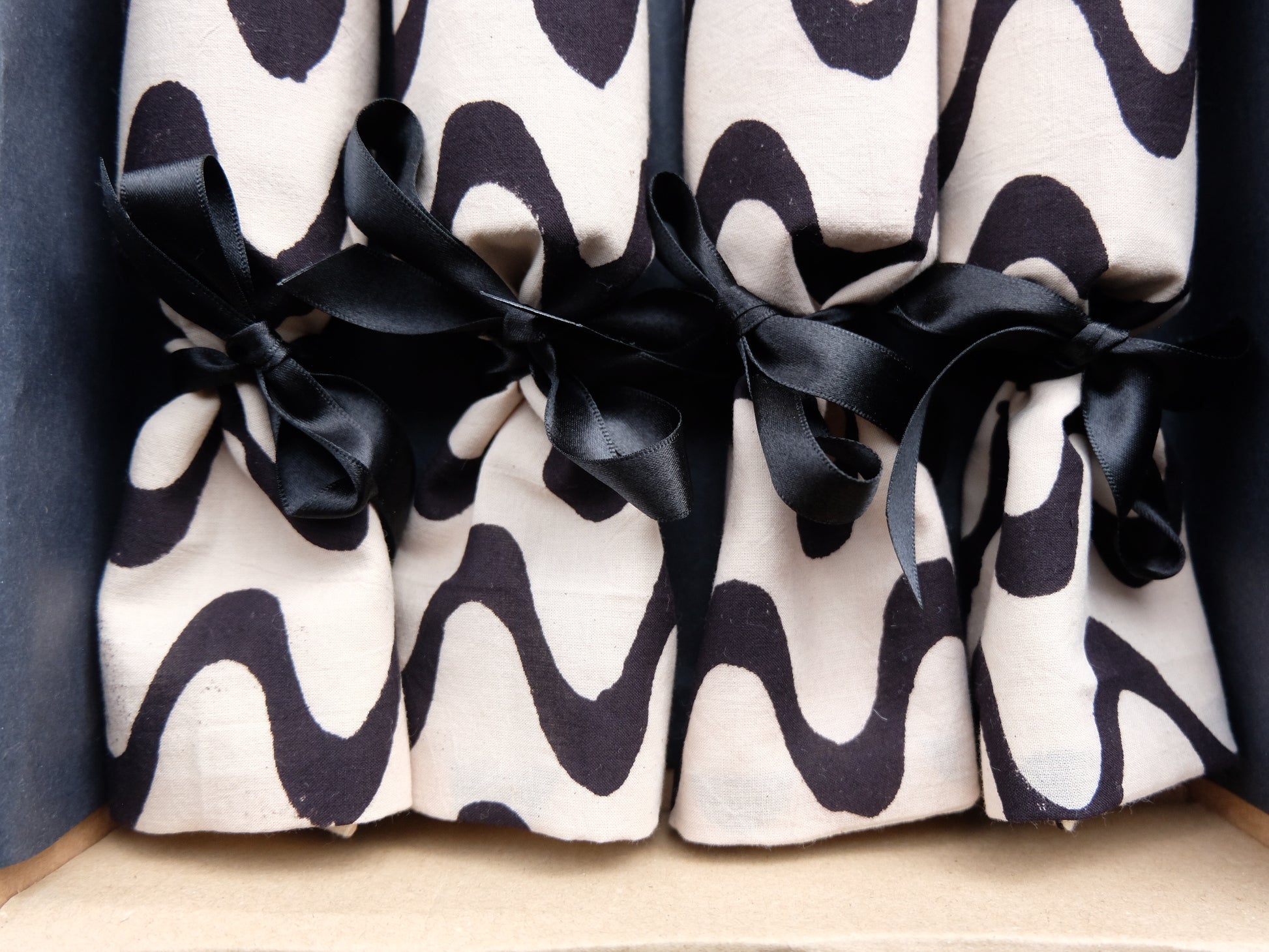 close up of waves print reusable luxury Christmas crackers in a box  